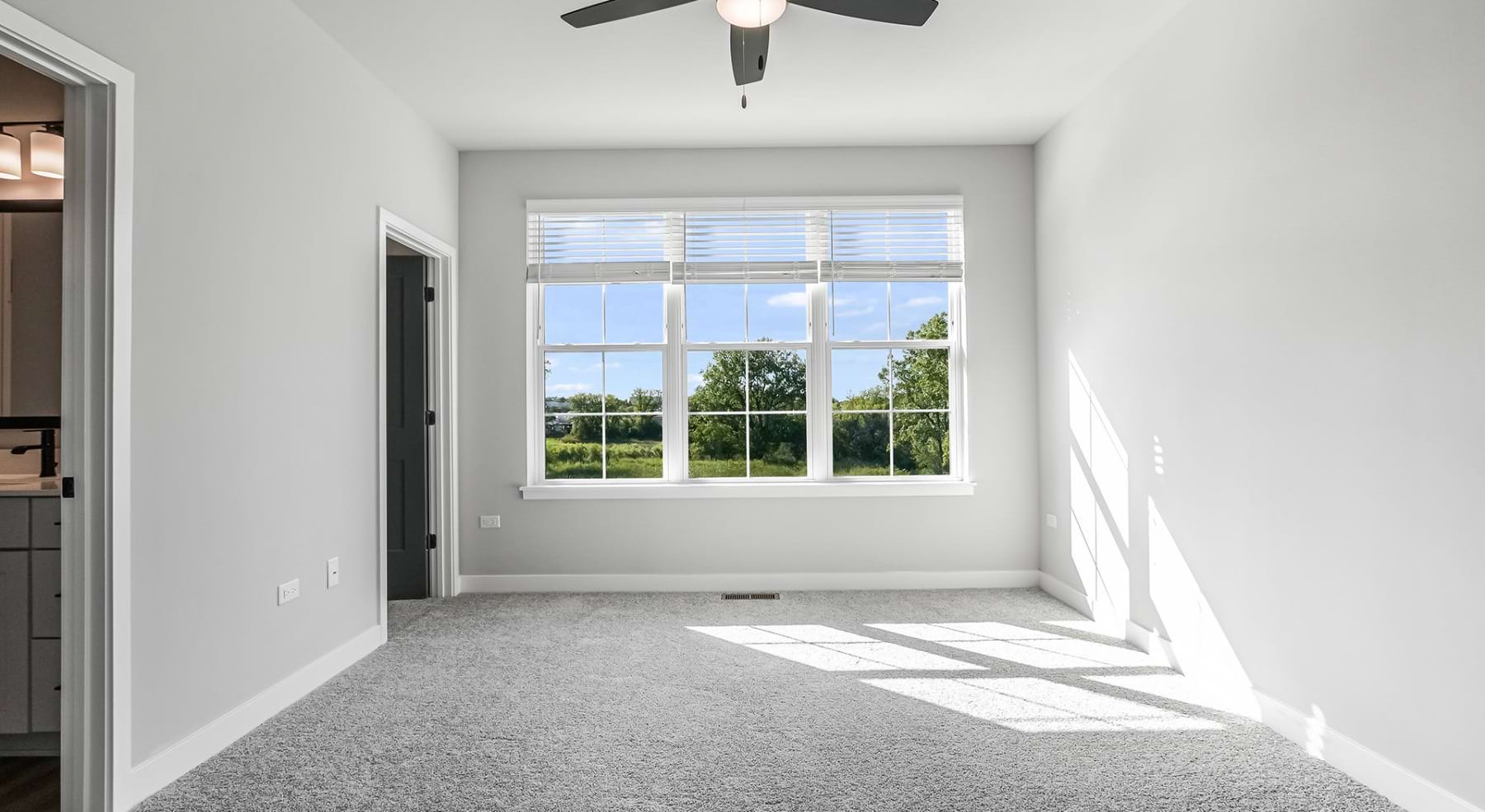 carpeted bedroom with large window