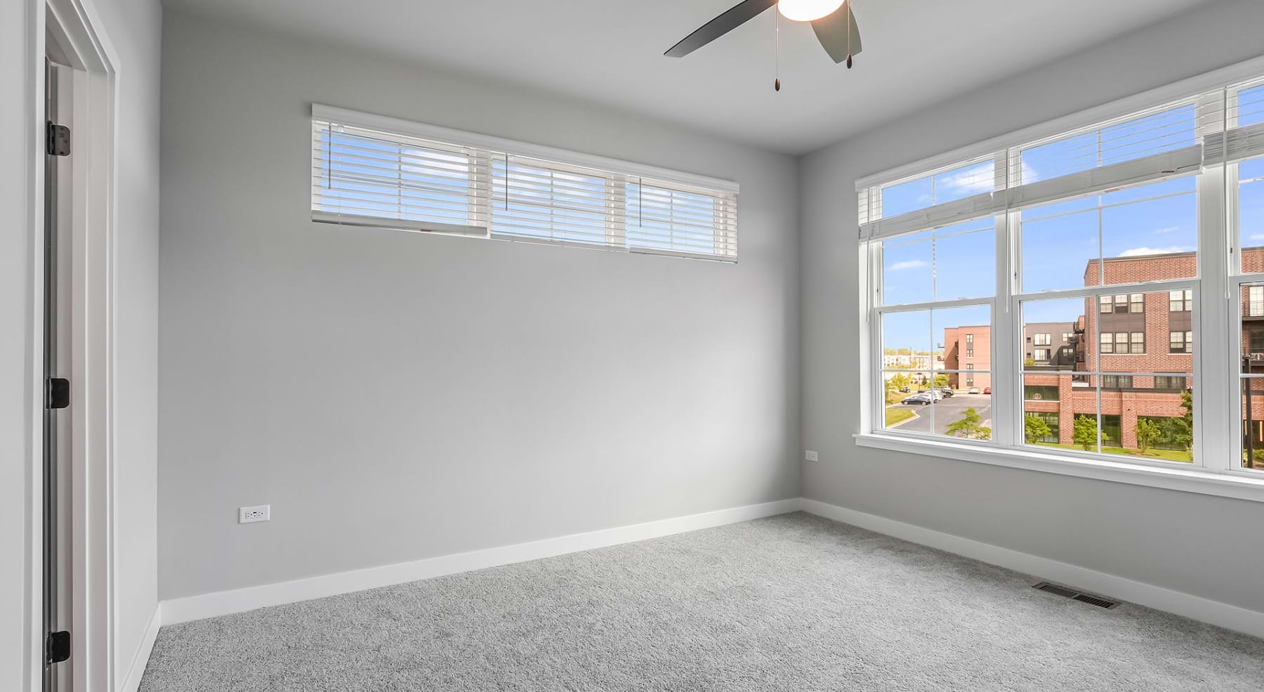 carpeted bedroom with natural lighting