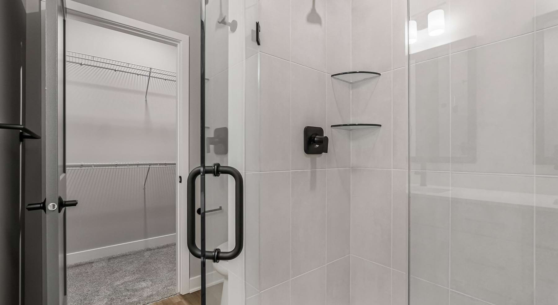 bathroom with walk-in shower and closet