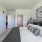 Bedroom With Lush Carpeting, Stylish Decor and Access to the Closet and Bathroom